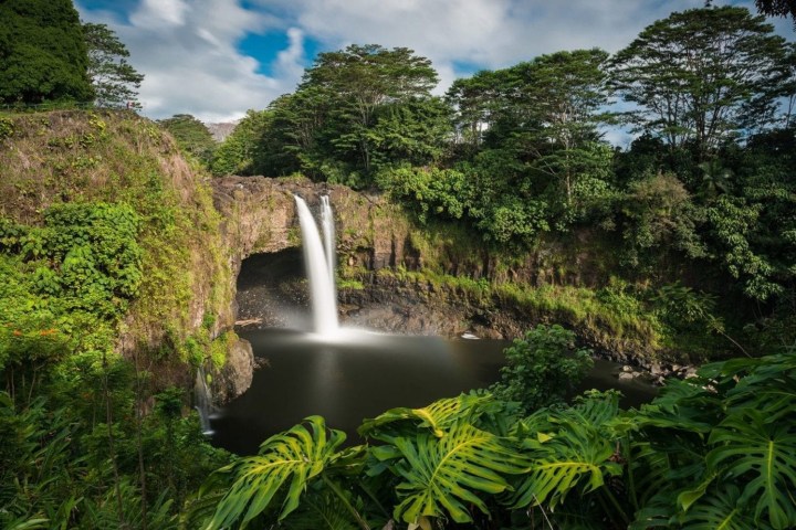 a large waterfall in a forest