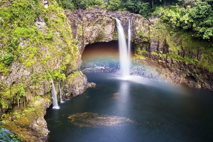 a large waterfall over a body of water