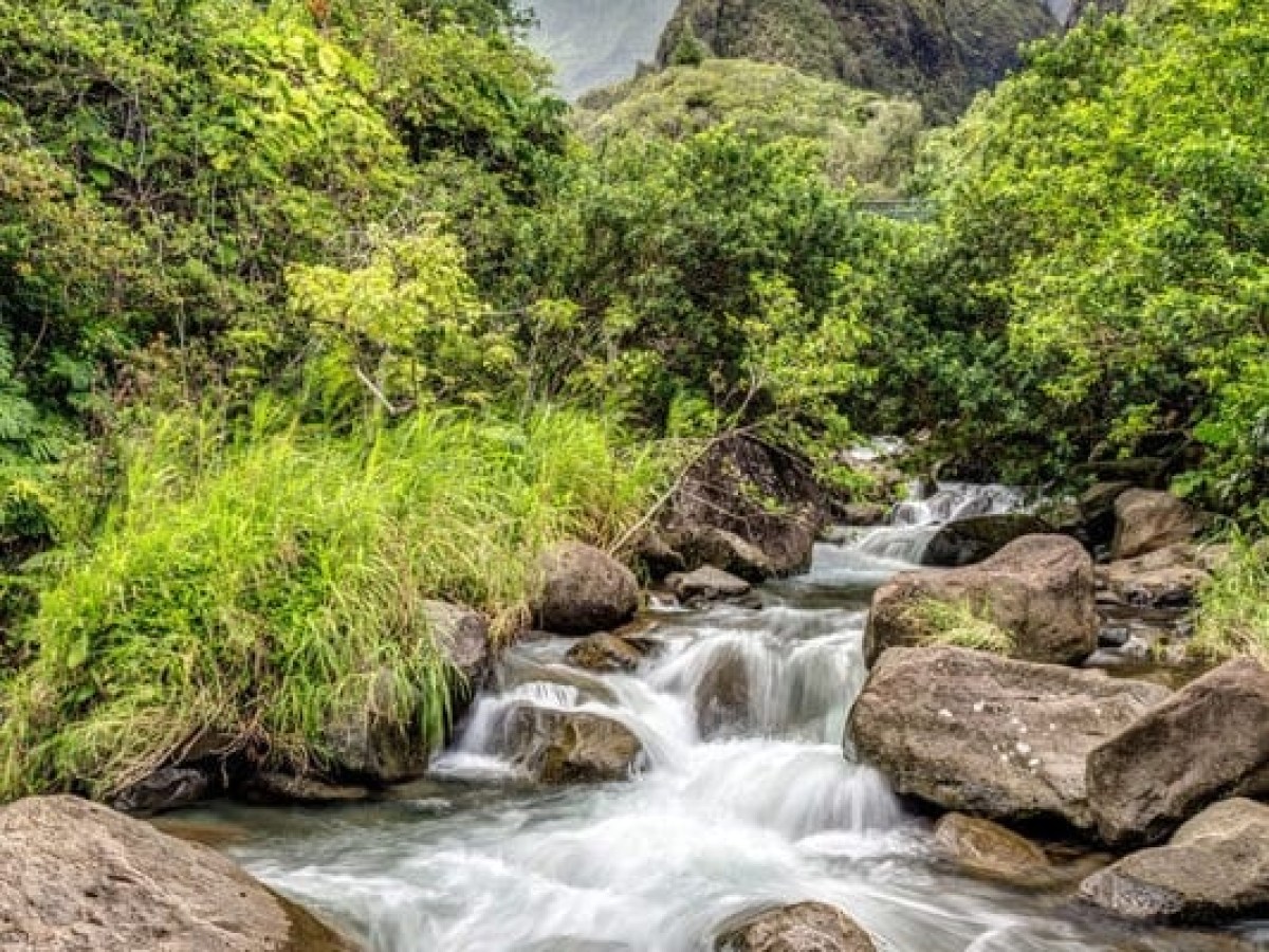 a large waterfall over a rocky cliff