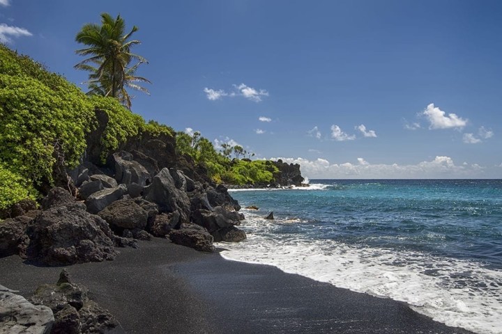a rocky beach next to a body of water