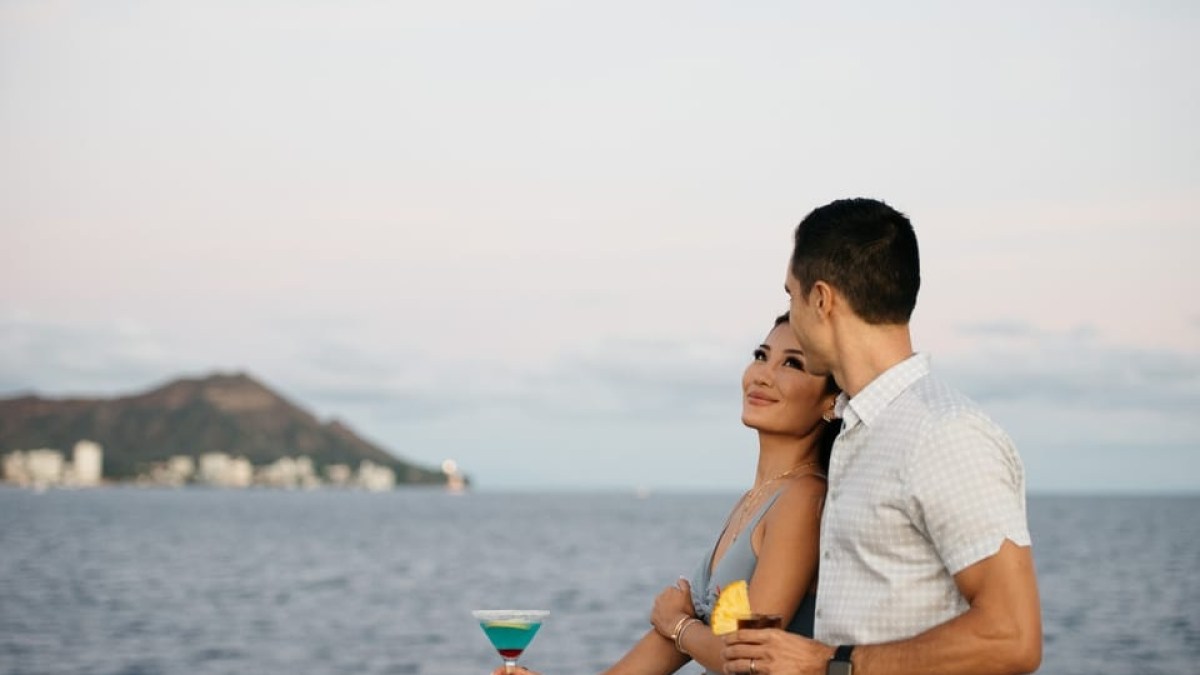 a man standing in front of a body of water