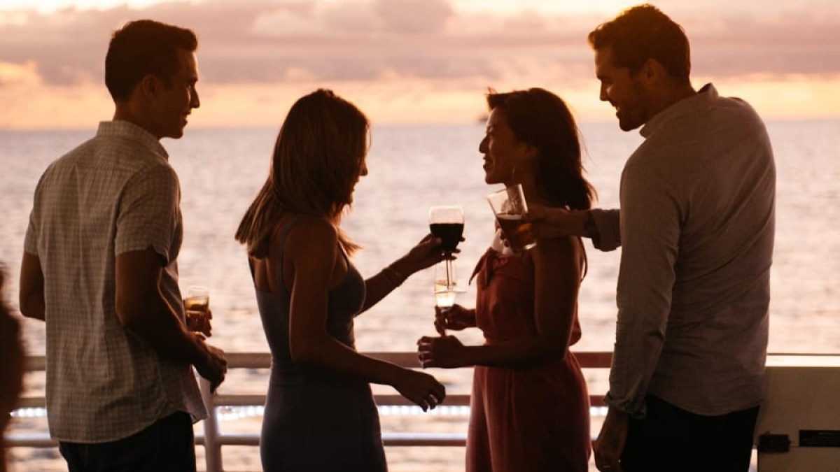 a group of people looking at a cell phone