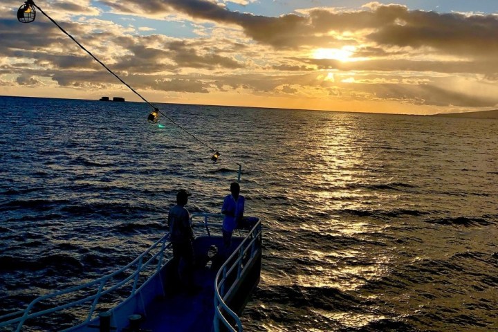 a man standing next to a body of water