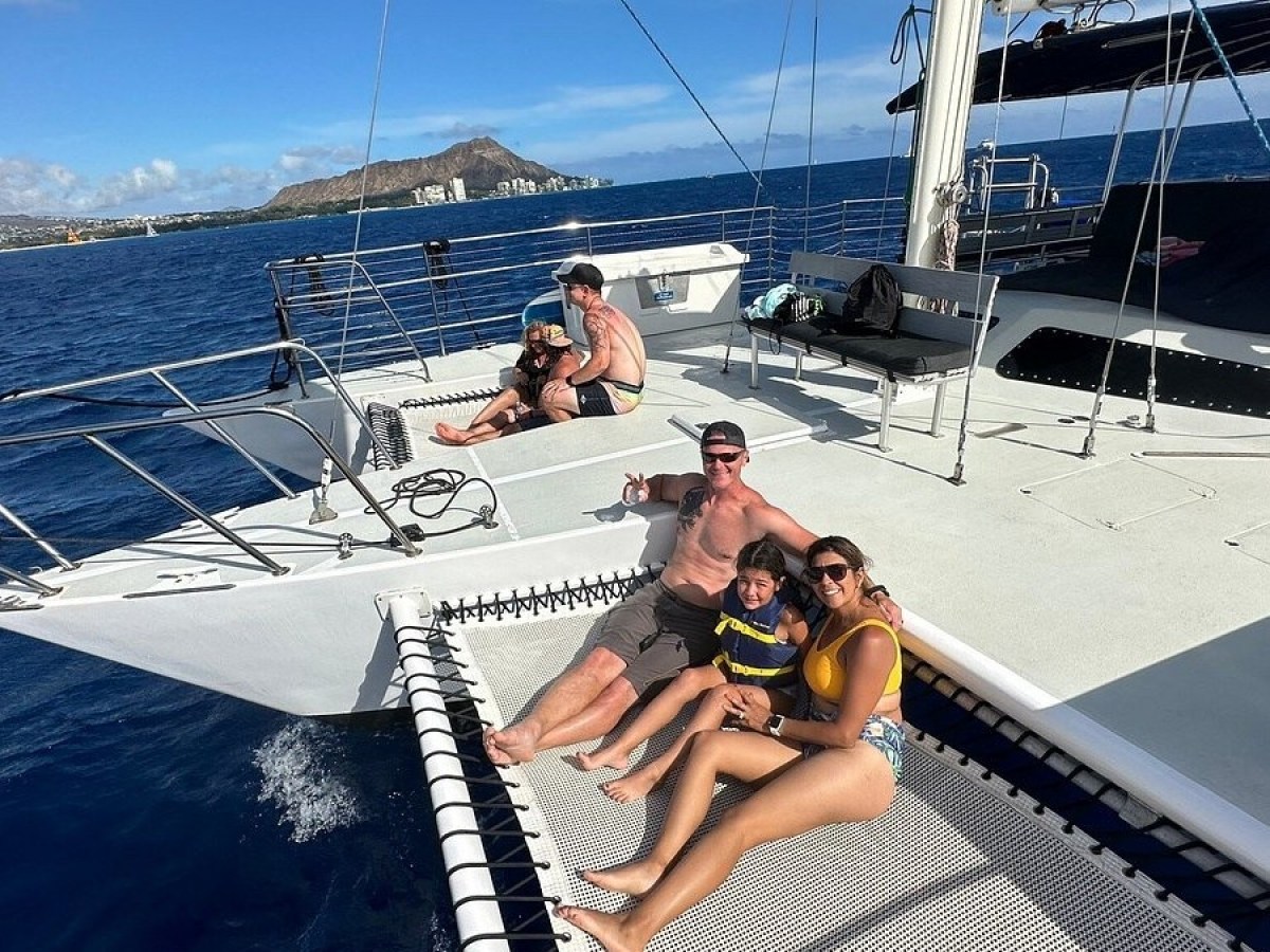 a person standing in front of a boat next to a body of water