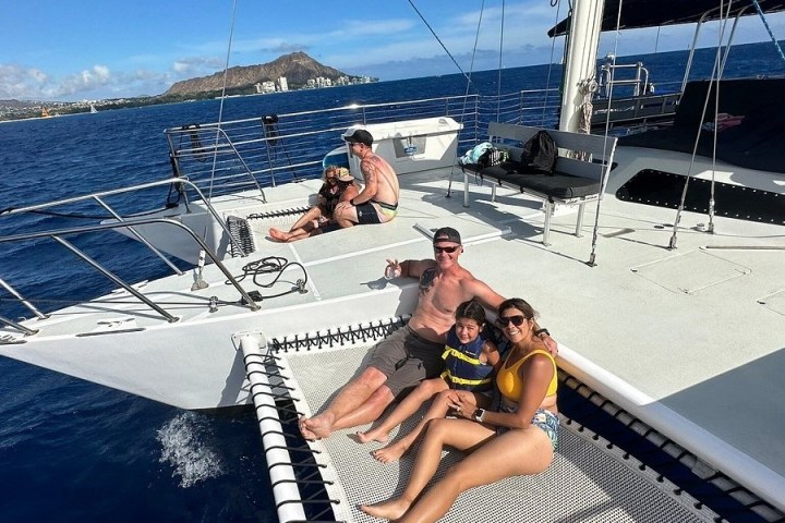 a person standing in front of a boat next to a body of water