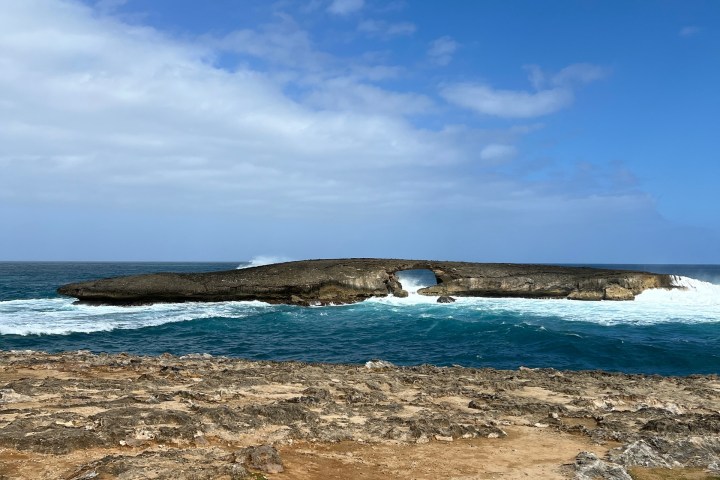 a sandy beach next to a body of water