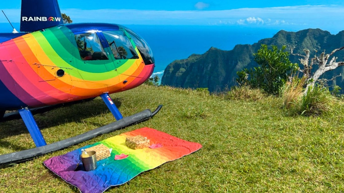 a colorful kite sitting on top of a grass covered field