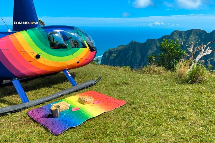 a colorful kite sitting on top of a grass covered field