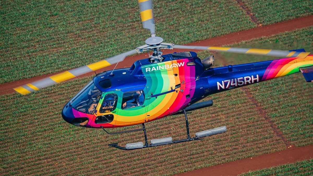 a colorful kite sitting on top of a grass covered field