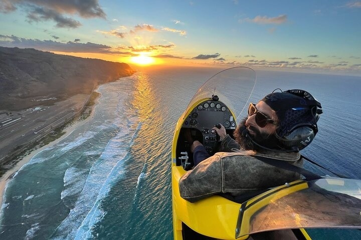a person riding a motorcycle next to a body of water
