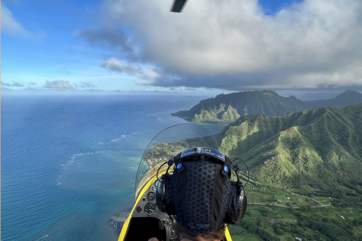 a man sitting on top of a mountain