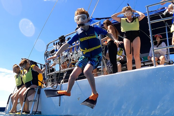 a group of people riding on the back of a boat