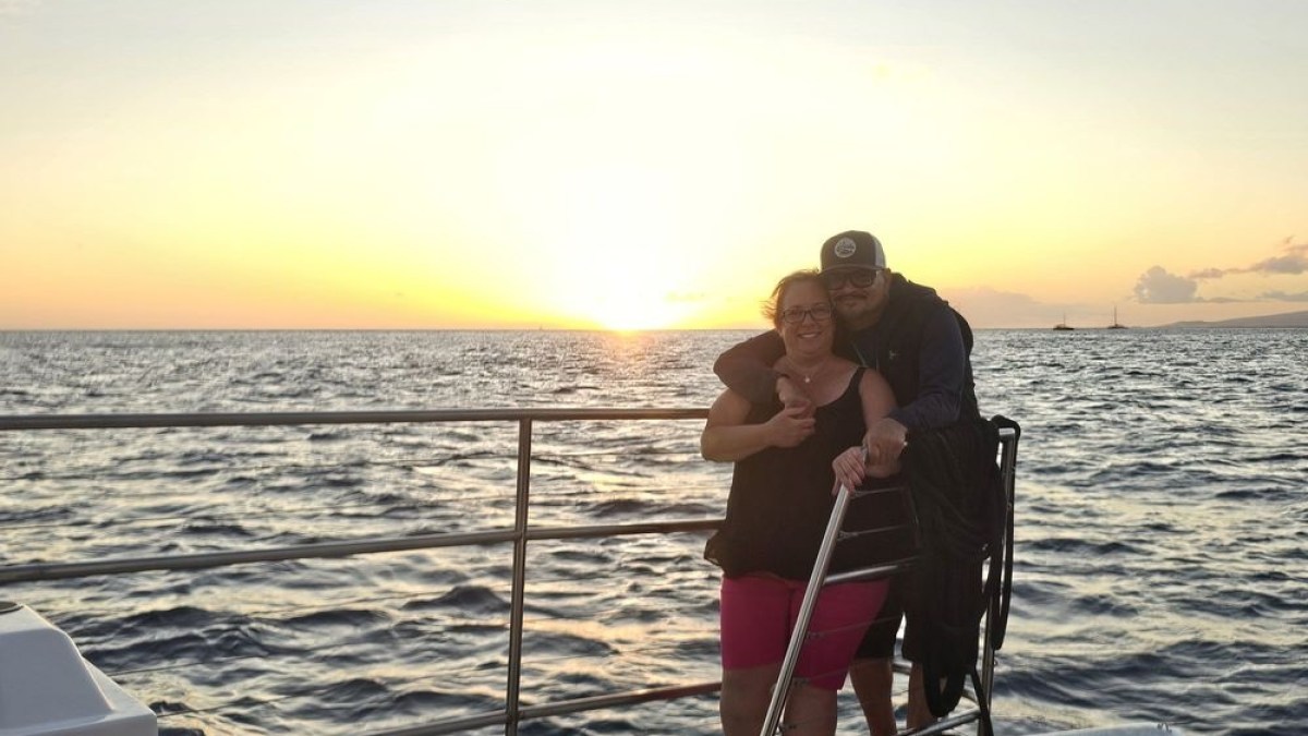 a person standing next to a body of water