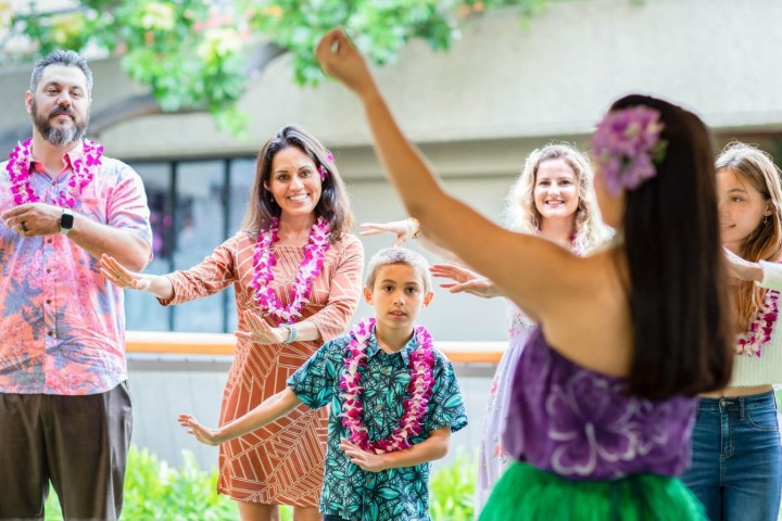 a group of people standing next to a girl