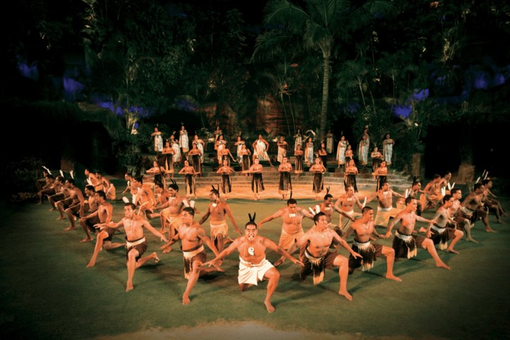 a group of people performing on stage in front of a crowd