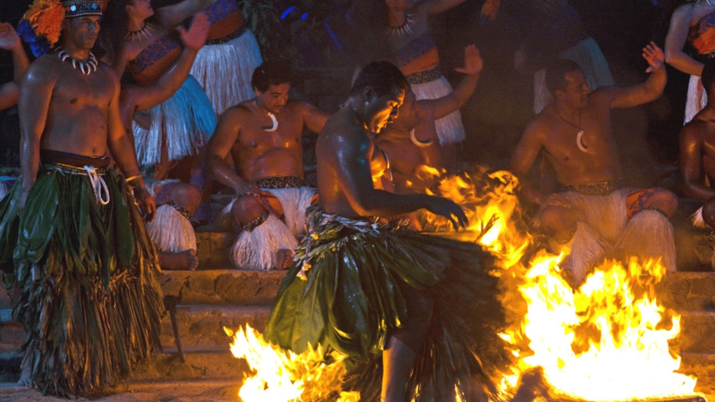 a group of people standing around a fire
