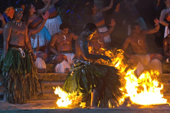 a group of people standing around a fire