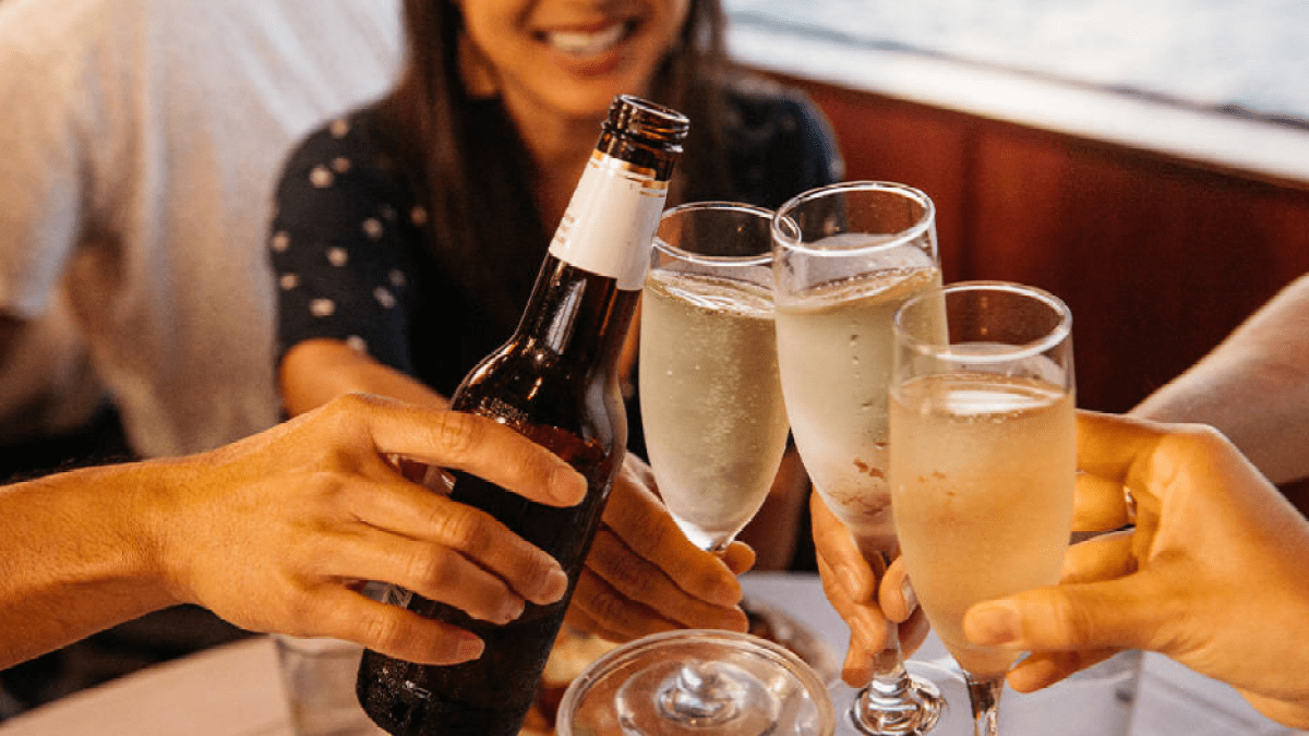 a woman sitting at a table with a glass of wine