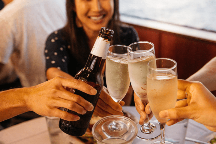 a woman sitting at a table with a glass of wine